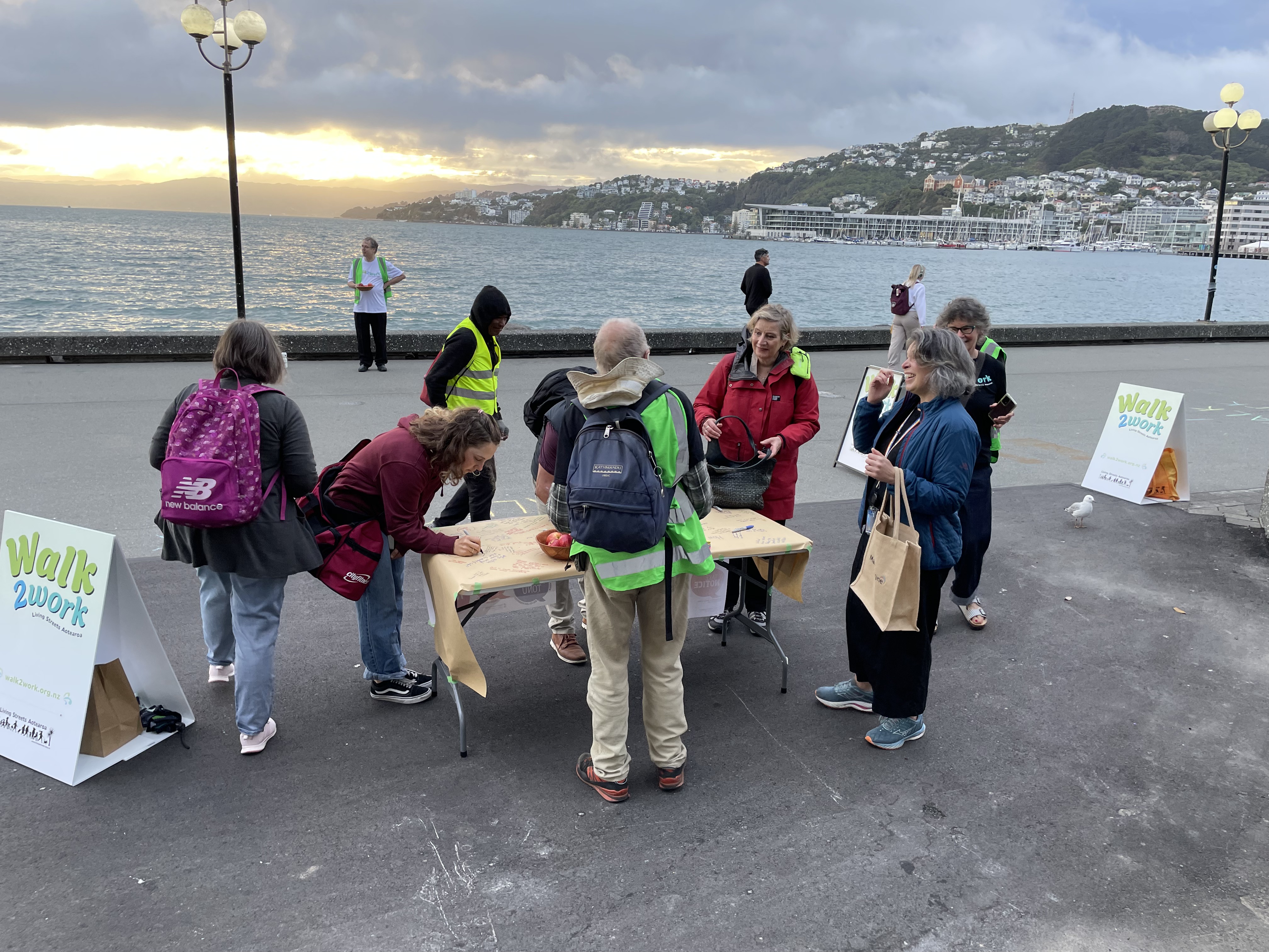 Wellington Waterfront. People writing comments on paper on a table. 