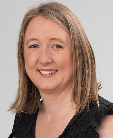 An image of Dr Angela Curl with shoulder-length blond hair and blue eyes, wearing a black shirt