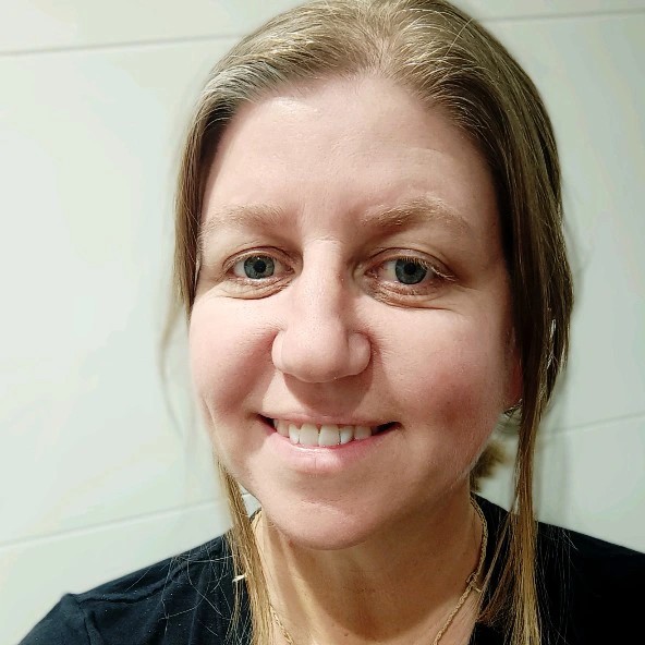 A headshot of Dr Bridget Doran with blond hair, blue eyes, and a black shirt