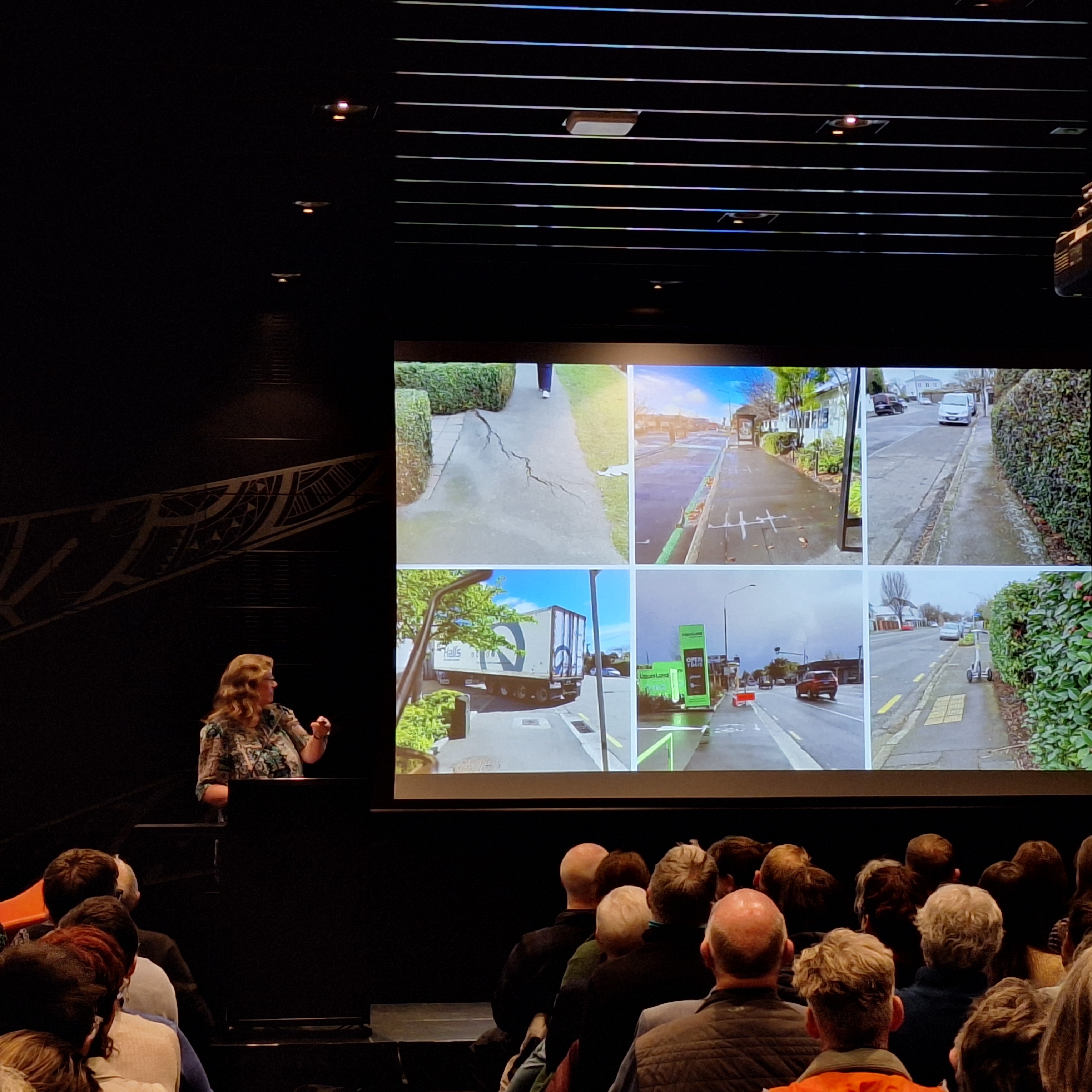 LSA Executive Council Member Carina Duke standing at a podium showing a slide of six photo examples of poorly designed and maintained footpaths