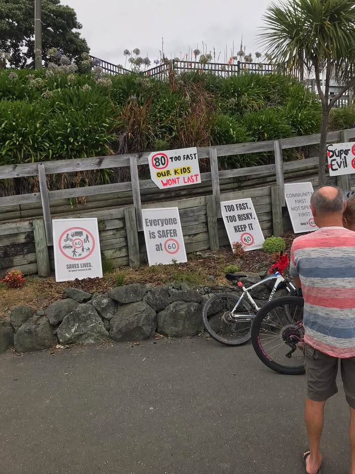 Protest signs hanging up alongside the road with keep it 60 in Atawhai